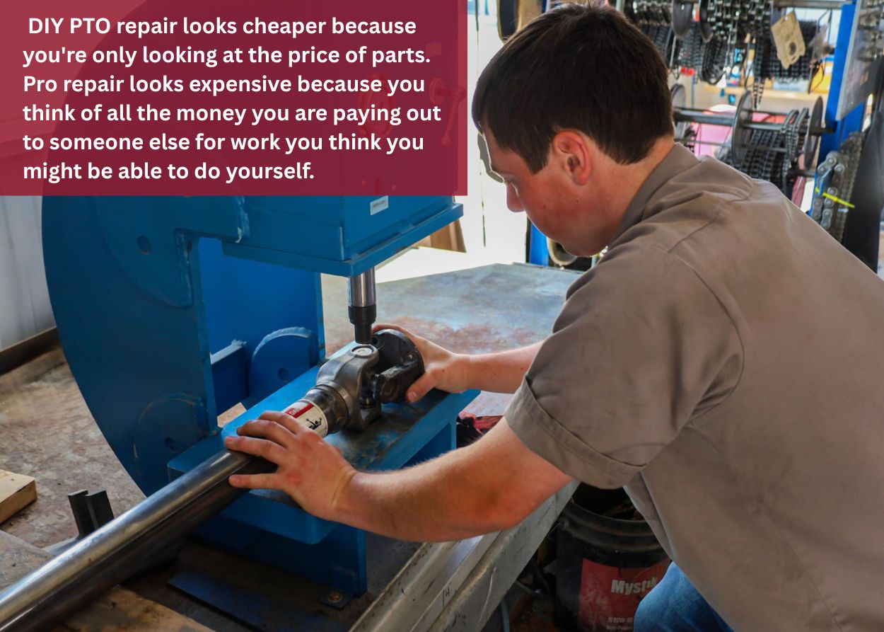Technician using a hydraulic press to service a PTO shaft, illustrating professional equipment used for safe and precise PTO repair.