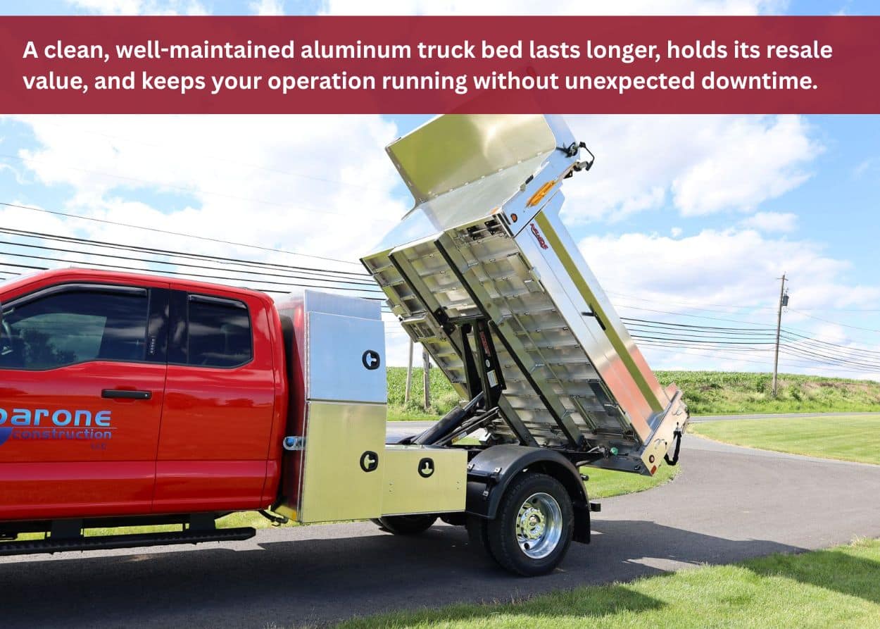 Dump-style aluminum truck bed lifted upward, showing clean underside and maintenance condition after proper cleaning